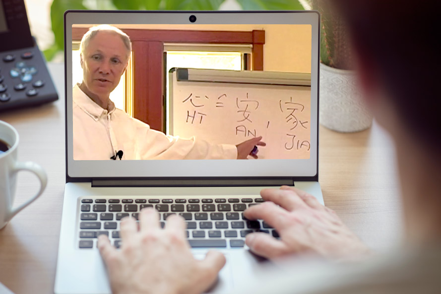 person with a laptop open and a man teaching