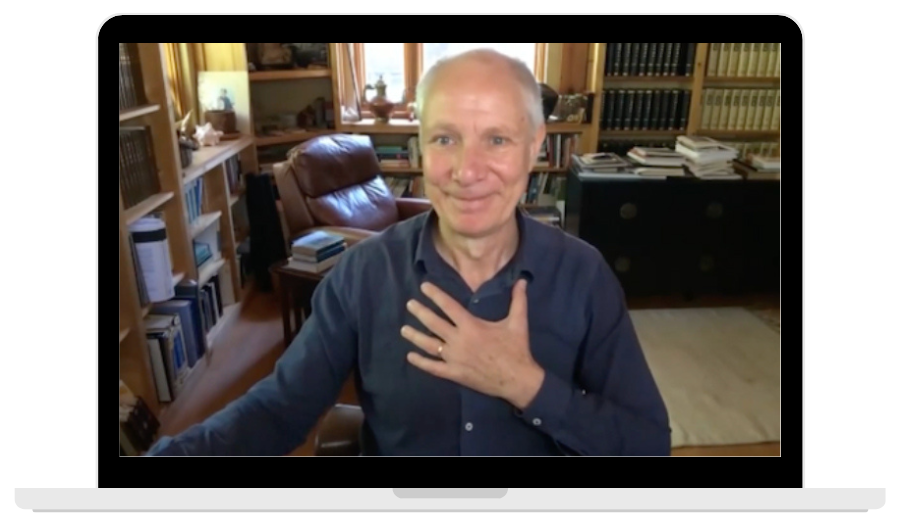 Heiner Fruehauf holds his hand over his heart in gratitude in an online classroom on the computer